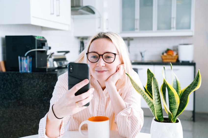 A woman watching a video on her phone.